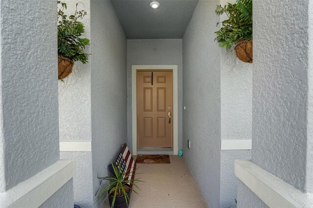 387 Avi Ct, Titusville, FL 32796 - property entrance featuring stucco siding