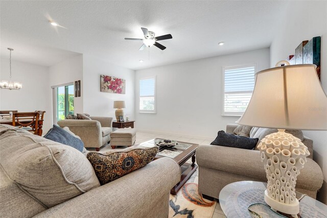 387 Avi Ct, Titusville, FL 32796 - tiled living area featuring plenty of natural light, a chandelier, a ceiling fan, and recessed lighting