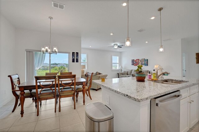 387 Avi Ct, Titusville, FL 32796 - kitchen featuring stainless steel dishwasher, a sink, white cabinets, pendant lighting, and light stone counters