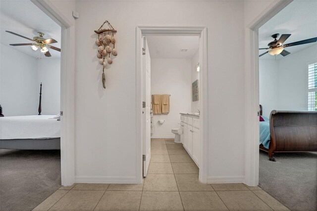 387 Avi Ct, Titusville, FL 32796 - hall with light tile patterned floors, baseboards, and light colored carpet