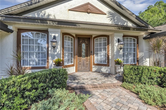 612 Golden Dawn, Apopka, FL 32712 - doorway to property featuring stucco siding and a porch