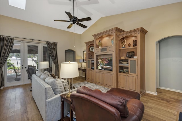 612 Golden Dawn, Apopka, FL 32712 - living area featuring vaulted ceiling, light wood finished floors, ceiling fan, arched walkways, and french doors
