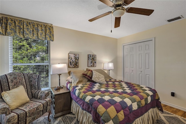 612 Golden Dawn, Apopka, FL 32712 - bedroom featuring wood finished floors, a closet, ceiling fan, baseboards, and a textured ceiling