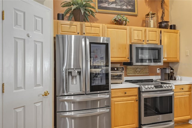 612 Golden Dawn, Apopka, FL 32712 - kitchen featuring stainless steel appliances, light countertops, and light brown cabinetry
