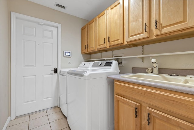 612 Golden Dawn, Apopka, FL 32712 - laundry room featuring washing machine and dryer, cabinet space, and light tile patterned floors