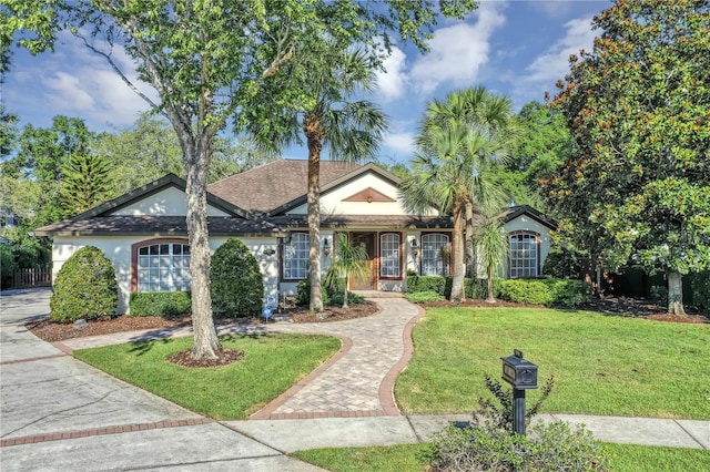 612 Golden Dawn, Apopka, FL 32712 - ranch-style home with a front lawn, a garage, stucco siding, and driveway