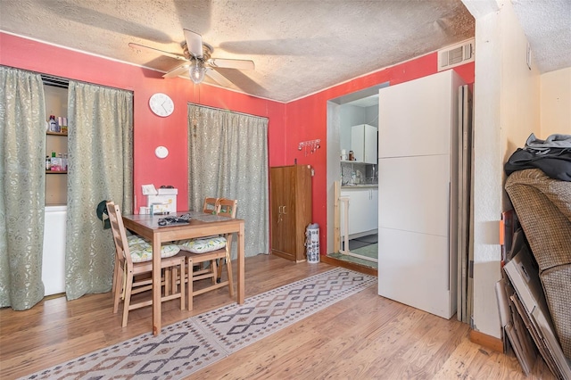 11509 Cameron St, Orlando, FL 32817 - dining space with ceiling fan, wood finished floors, and a textured ceiling
