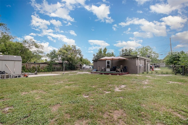 11509 Cameron St, Orlando, FL 32817 - view of yard featuring a wooden deck and a storage shed