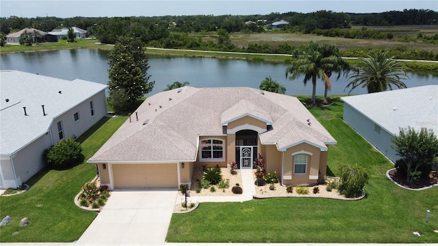 27143 Nostalgia Dr, Leesburg, FL 34748 - view of front facade with an attached garage, stucco siding, a water view, and concrete driveway