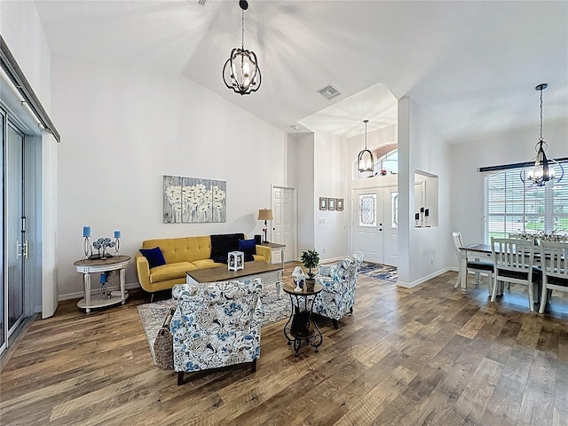 27143 Nostalgia Dr, Leesburg, FL 34748 - living area with a chandelier, wood finished floors, high vaulted ceiling, and baseboards