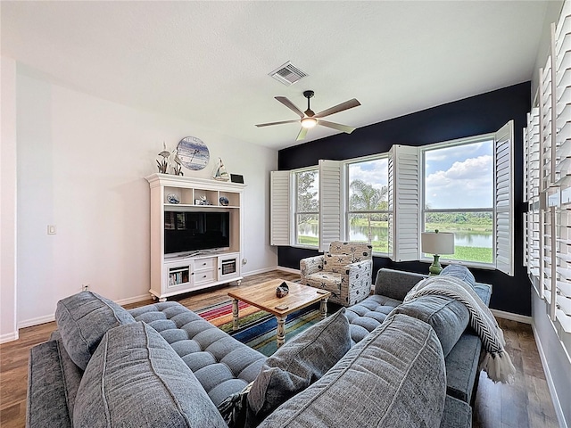 27143 Nostalgia Dr, Leesburg, FL 34748 - living area with ceiling fan, baseboards, and wood finished floors
