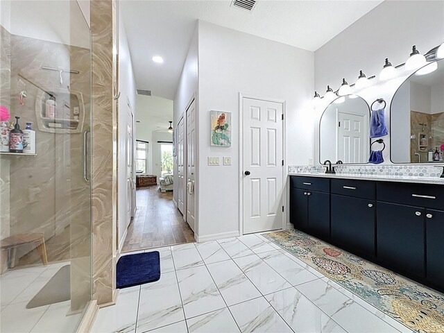 27143 Nostalgia Dr, Leesburg, FL 34748 - full bathroom with double vanity, a stall shower, and marble finish flooring