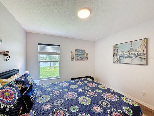 27143 Nostalgia Dr, Leesburg, FL 34748 - bedroom with a textured ceiling and baseboards