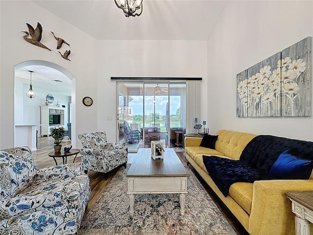 27143 Nostalgia Dr, Leesburg, FL 34748 - living room with wood finished floors, arched walkways, and a towering ceiling