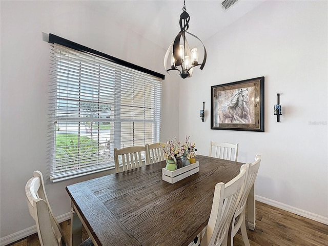 27143 Nostalgia Dr, Leesburg, FL 34748 - dining area with baseboards, healthy amount of natural light, a chandelier, and wood finished floors