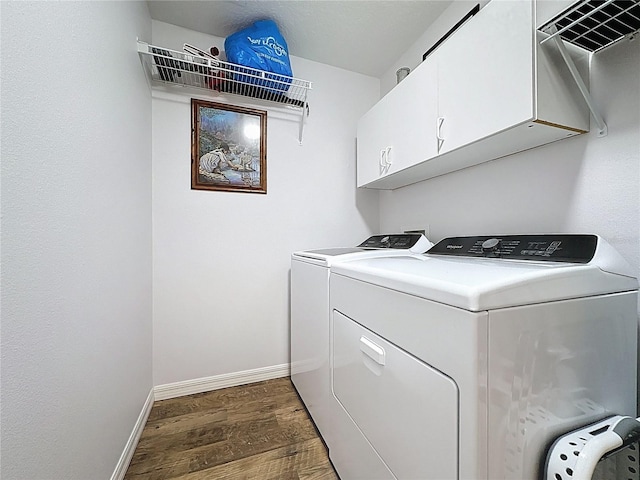 27143 Nostalgia Dr, Leesburg, FL 34748 - washroom featuring washer and dryer, wood finished floors, cabinet space, and baseboards