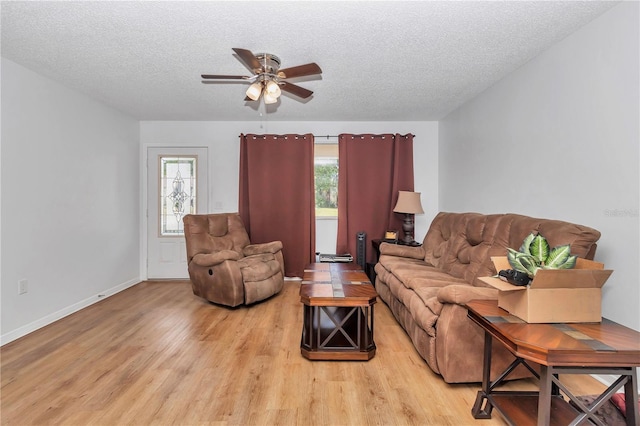 8443 SW 109th Pl, Ocala, FL 34481 - living room featuring light wood finished floors, ceiling fan, a textured ceiling, and plenty of natural light