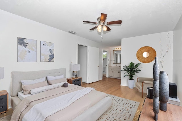 8443 SW 109th Pl, Ocala, FL 34481 - bedroom with light wood-style floors, ensuite bathroom, baseboards, and a ceiling fan