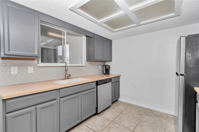 8443 SW 109th Pl, Ocala, FL 34481 - kitchen with appliances with stainless steel finishes, a sink, gray cabinets, light countertops, and baseboards