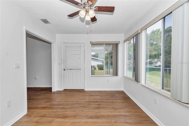 8443 SW 109th Pl, Ocala, FL 34481 - unfurnished room with ceiling fan, a textured ceiling, light wood finished floors, and baseboards