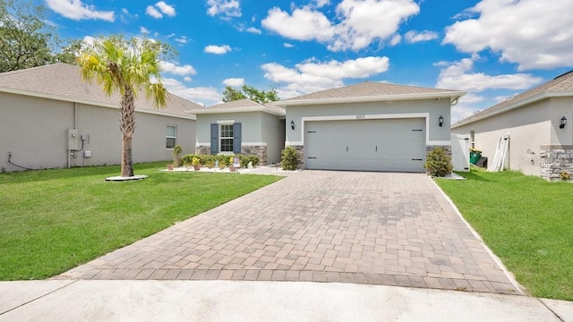 6013 Mount Zion Cir, Deland, FL 32724 - view of front of property featuring decorative driveway, a garage, stucco siding, and a front yard