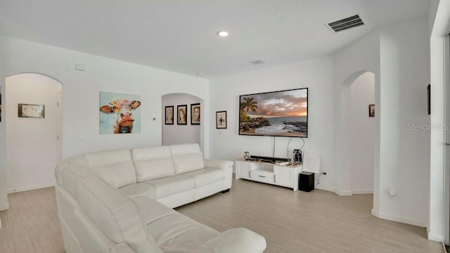 6013 Mount Zion Cir, Deland, FL 32724 - living area with arched walkways, light wood-type flooring, recessed lighting, and baseboards