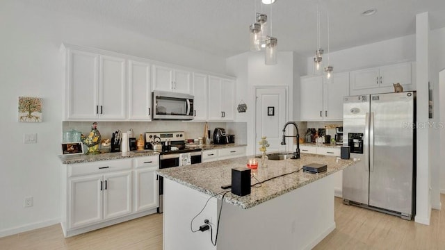 6013 Mount Zion Cir, Deland, FL 32724 - kitchen with appliances with stainless steel finishes, a sink, white cabinetry, and light wood-style floors