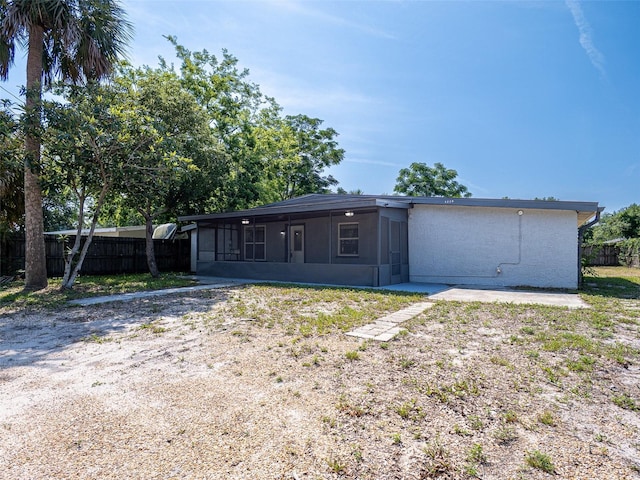 1229 Deneece Ter, Daytona Beach, FL 32117 - rear view of property featuring a sunroom and stucco siding
