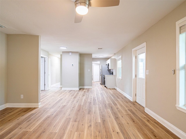 1229 Deneece Ter, Daytona Beach, FL 32117 - unfurnished living room with light wood-style flooring, ceiling fan, and baseboards