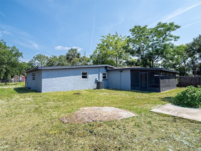 1229 Deneece Ter, Daytona Beach, FL 32117 - back of property featuring a sunroom, cooling unit, and stucco siding