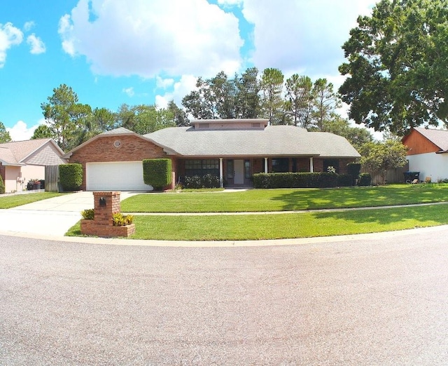 7618 Majestic Pine Ct, Orlando, FL 32819 - view of front of home featuring concrete driveway, an attached garage, and a front yard