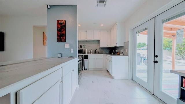 331 Greens End St, Orlando, FL 32810 - kitchen with light marble finish flooring, a sink, tasteful backsplash, french doors, and white cabinetry