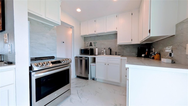 331 Greens End St, Orlando, FL 32810 - kitchen featuring appliances with stainless steel finishes, a sink, backsplash, light countertops, and recessed lighting