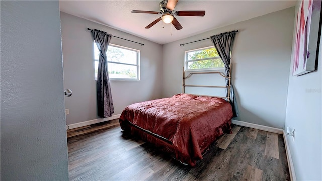 331 Greens End St, Orlando, FL 32810 - bedroom with wood finished floors, baseboards, and ceiling fan