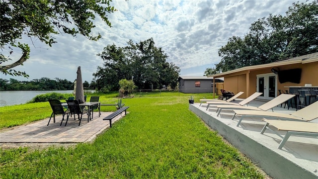 331 Greens End St, Orlando, FL 32810 - view of yard with french doors, a patio, and a water view
