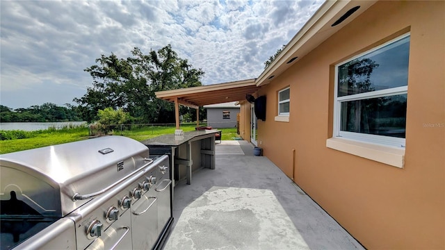 331 Greens End St, Orlando, FL 32810 - view of patio / terrace with grilling area and a water view