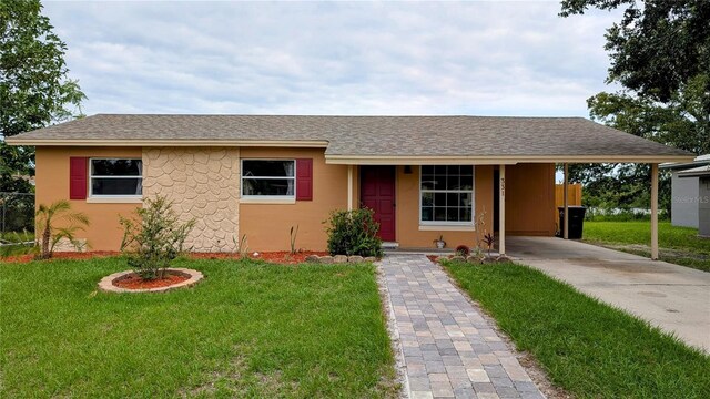 331 Greens End St, Orlando, FL 32810 - ranch-style home featuring driveway, a front lawn, an attached carport, and stucco siding