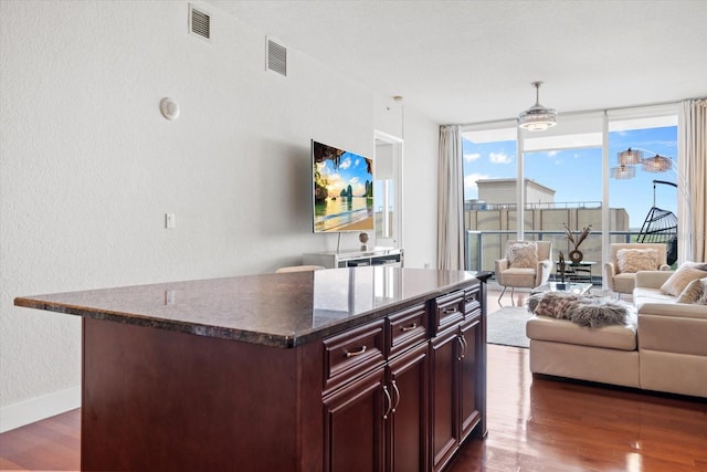 150 E Robinson St Unit 16B-2 # 1605, Orlando, FL 32801 - living area with dark wood finished floors, a wall of windows, baseboards, and a textured wall