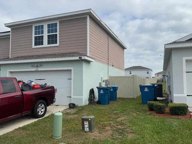 268 Fiddlewood Ct, Davenport, FL 33837 - view of property exterior featuring an attached garage, driveway, and central AC unit