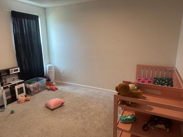 268 Fiddlewood Ct, Davenport, FL 33837 - recreation room with carpet floors and baseboards