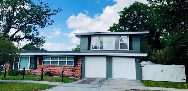 1919 E S St, Orlando, FL 32801 - tri-level home with an attached garage, brick siding, concrete driveway, and a gate