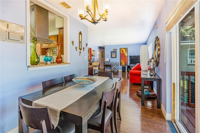 1919 E S St, Orlando, FL 32801 - dining room with a chandelier, wood finished floors, and baseboards