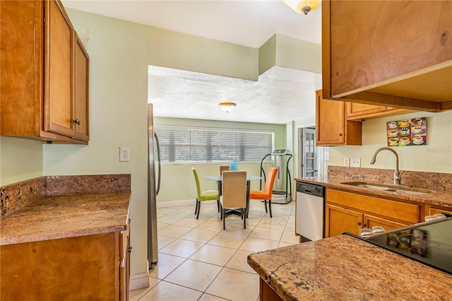 1919 E S St, Orlando, FL 32801 - kitchen with stainless steel appliances, a sink, and brown cabinetry