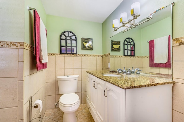 1919 E S St, Orlando, FL 32801 - bathroom with tile walls, vanity, tile patterned floors, toilet, and a wainscoted wall