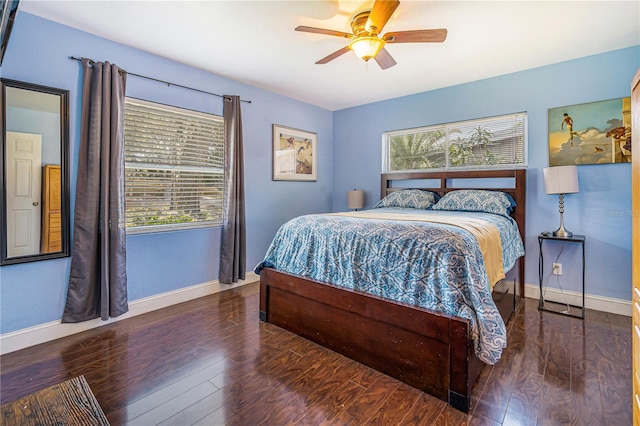 1919 E S St, Orlando, FL 32801 - bedroom with baseboards, multiple windows, wood finished floors, and a ceiling fan