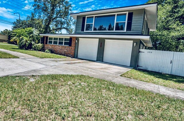 1919 E S St, Orlando, FL 32801 - view of front of home with driveway, a garage, and brick siding