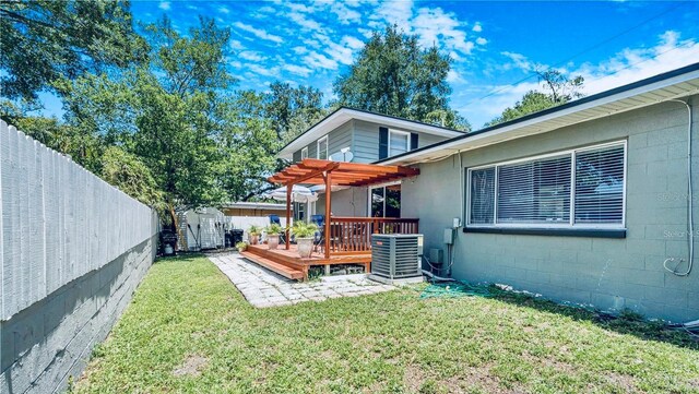 1919 E S St, Orlando, FL 32801 - rear view of property with central AC, a pergola, a deck, and concrete block siding
