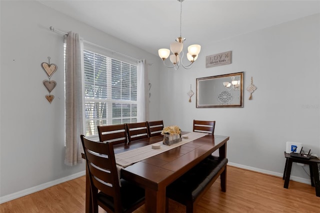 1245 Reagans Reserve Blvd, Apopka, FL 32712 - dining room with a chandelier, light wood-style floors, and baseboards