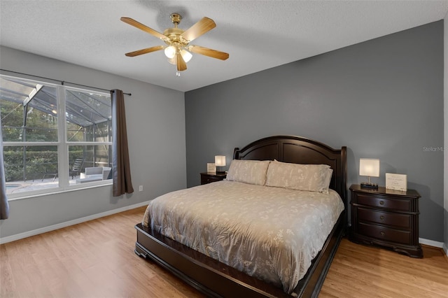 1245 Reagans Reserve Blvd, Apopka, FL 32712 - bedroom with wood finished floors, baseboards, a ceiling fan, and a textured ceiling