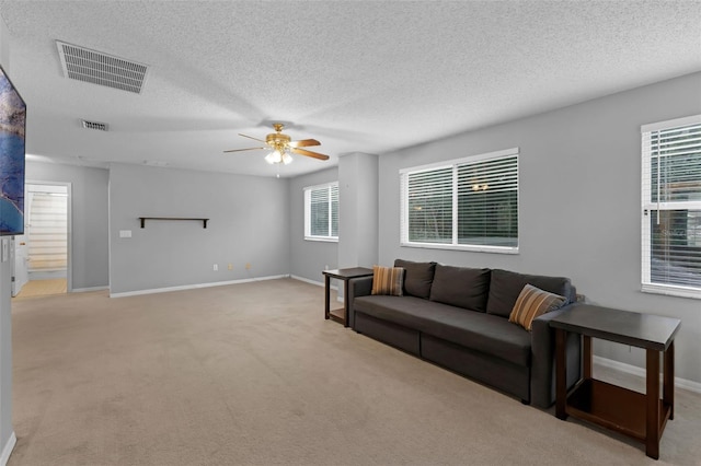 1245 Reagans Reserve Blvd, Apopka, FL 32712 - living room featuring a textured ceiling, a ceiling fan, carpet, and baseboards